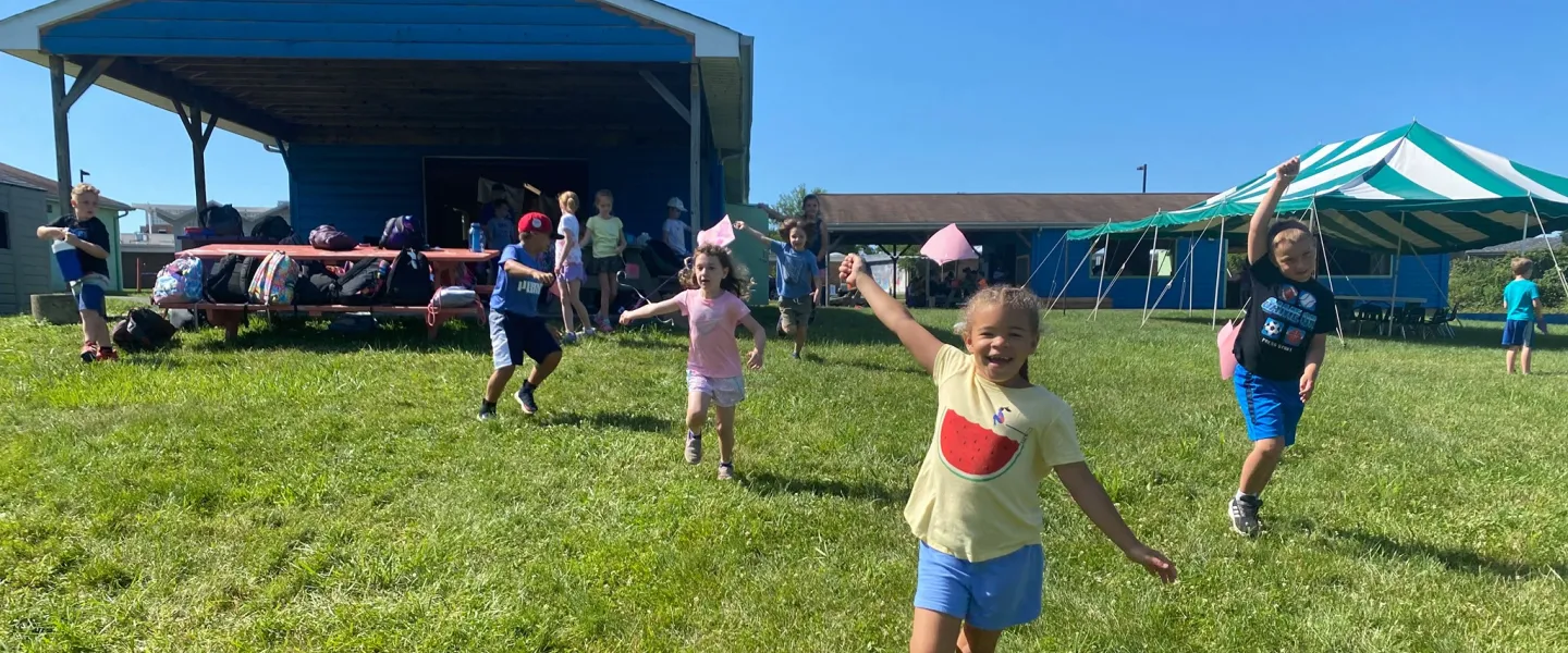 girl running down hill at summer camp