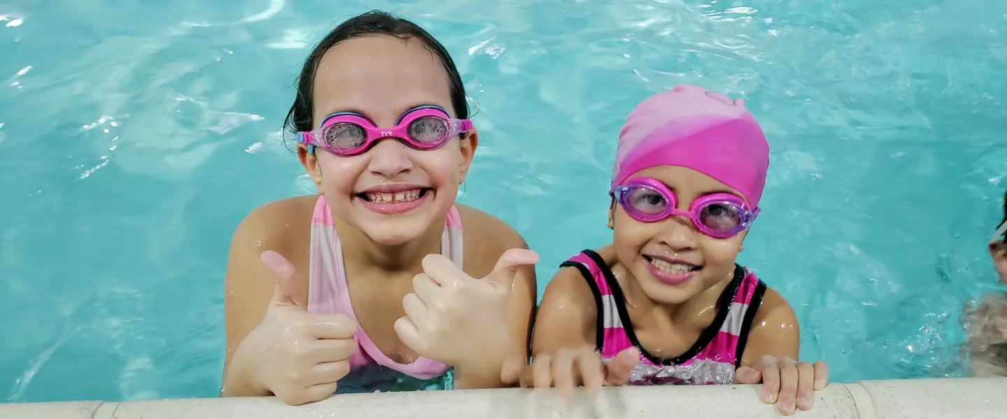 young girls smiling in pool