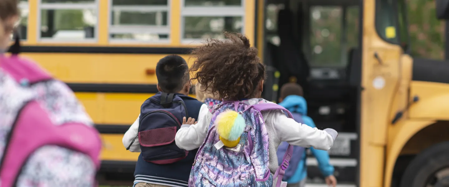child running to school bus