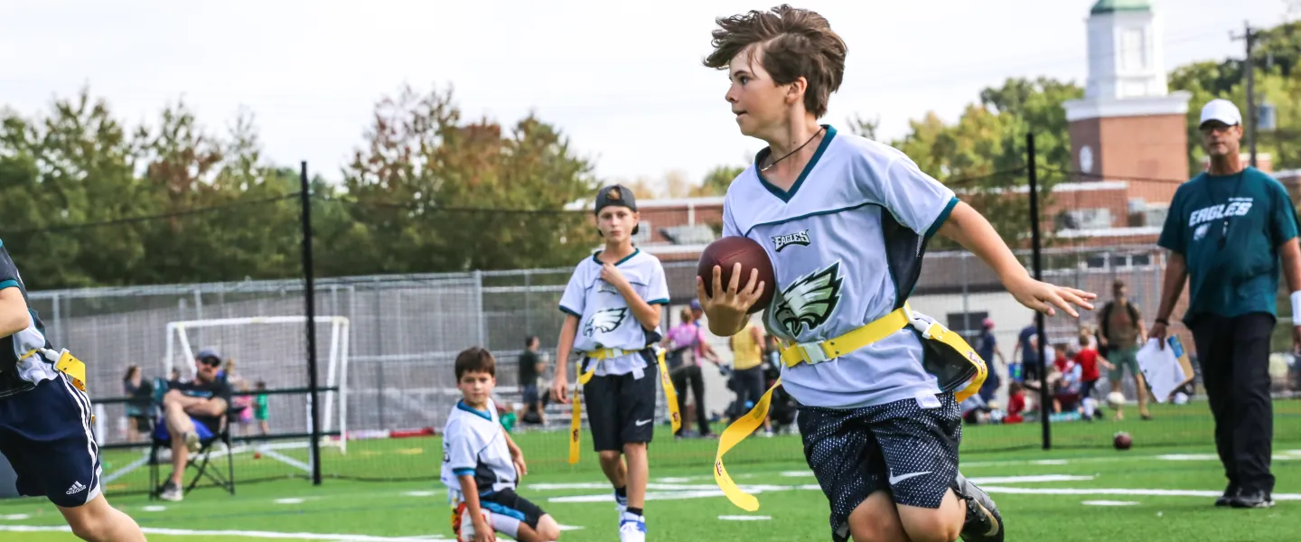 young teen playing flag football