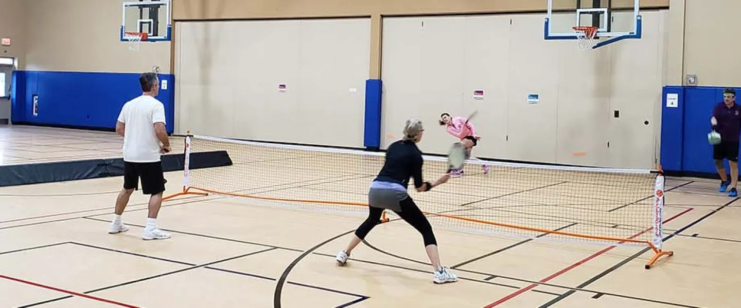 adults playing pickleball