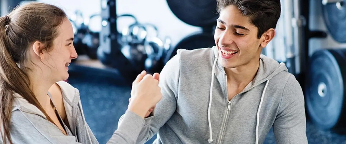 teen fist bump in fitness center