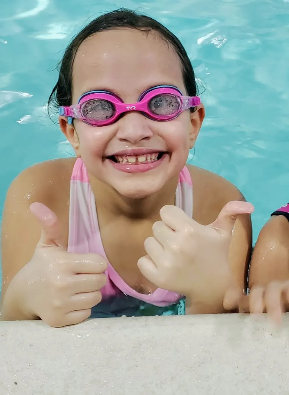 young girls smiling in pool