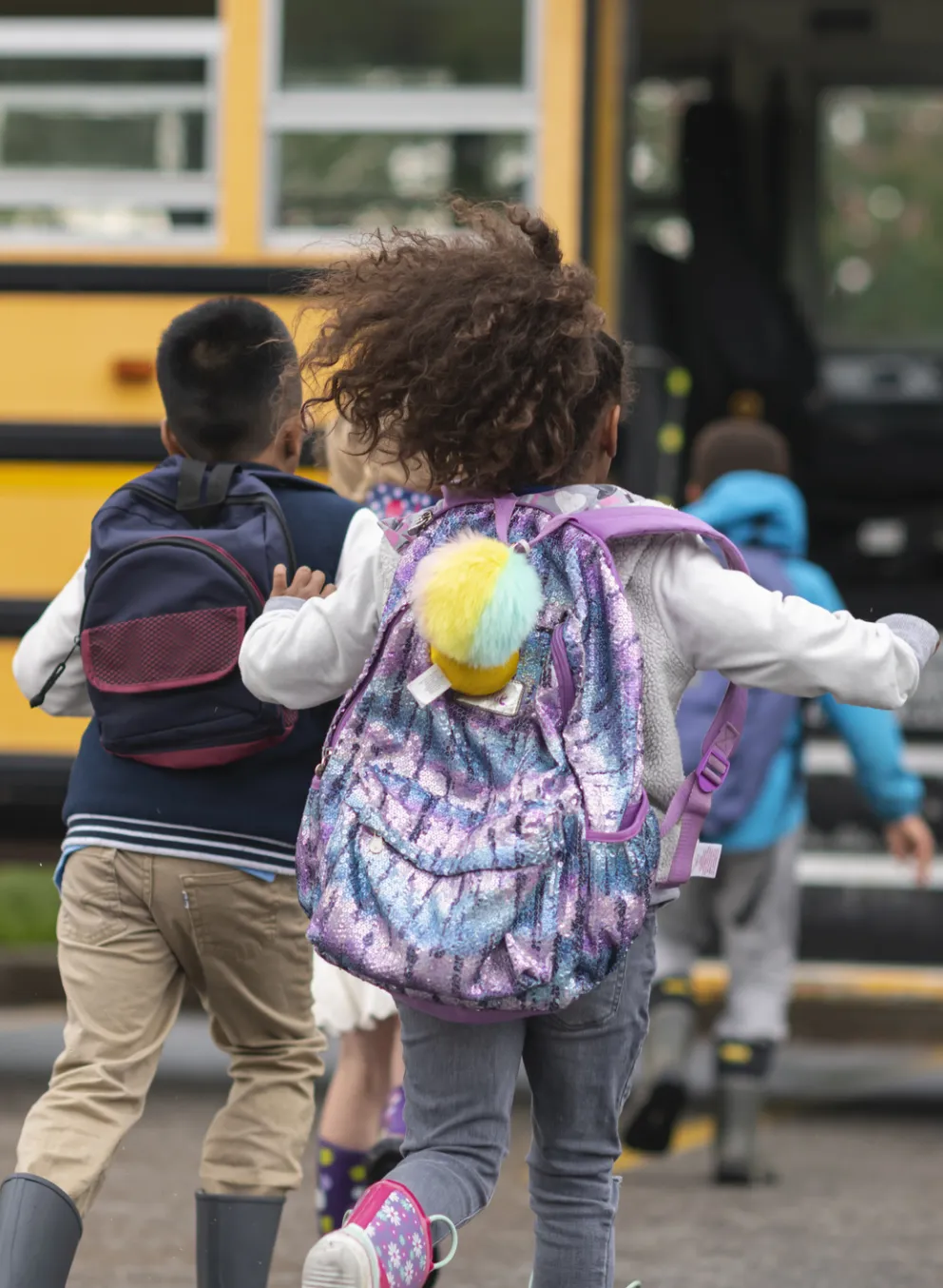 child running to school bus