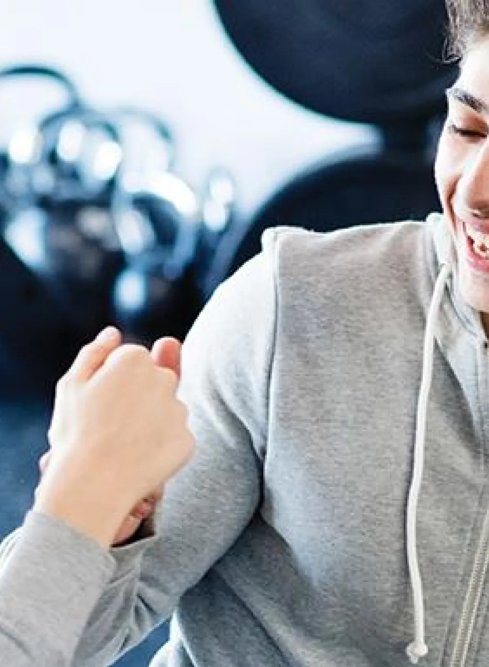 teen fist bump in fitness center