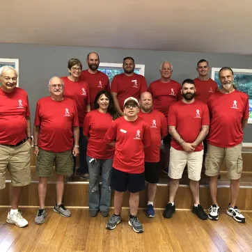 veterans in red shirts group photo