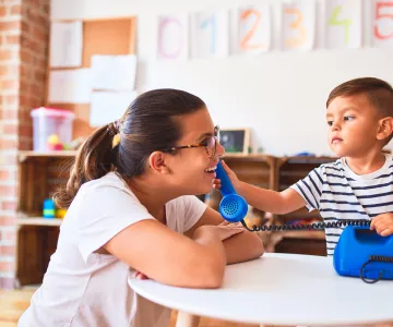 child playing phone with teacher