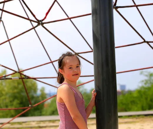 girl standing under play equipment