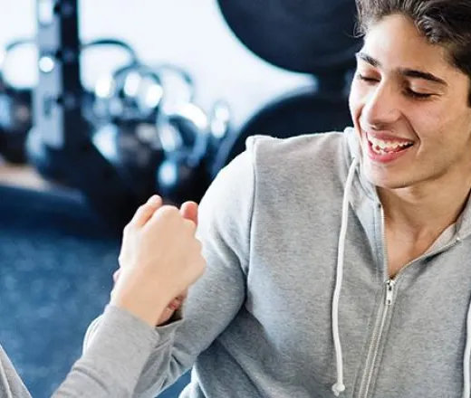 teen fist bump in fitness center