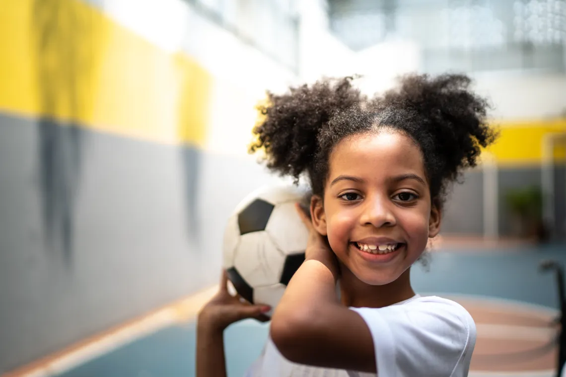 girl holding soccer ball
