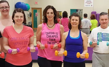 group of adults holding weights